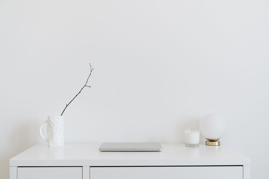 Minimalist white desk with an open laptop, representing HumaticAI's global subscription billing integration with Paddle